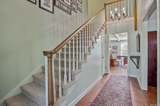 stairway featuring hardwood / wood-style floors and crown molding