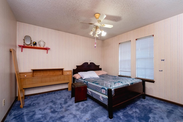 carpeted bedroom with ceiling fan and a textured ceiling