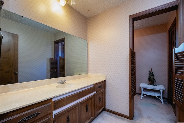 bathroom with vanity and a textured ceiling