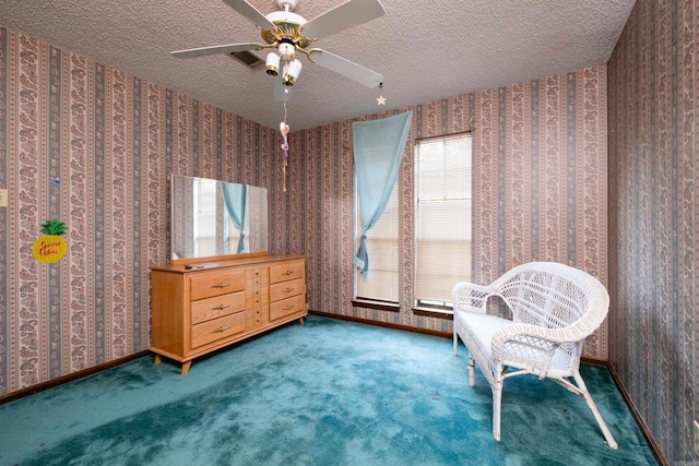 living area featuring ceiling fan, a textured ceiling, and carpet floors