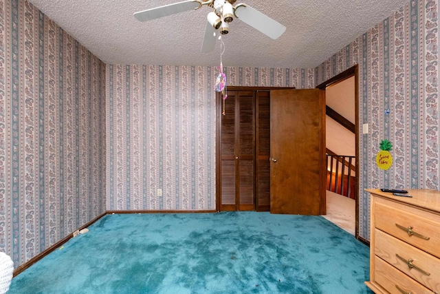 interior space with a textured ceiling and ceiling fan