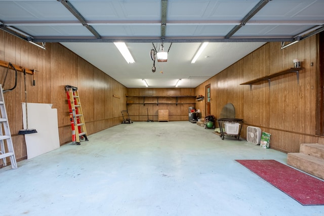 garage featuring wood walls and a garage door opener