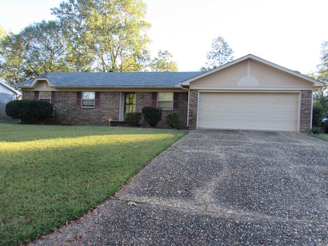 ranch-style house featuring a garage and a front lawn