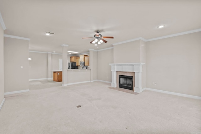 unfurnished living room with ornamental molding, light carpet, and ceiling fan