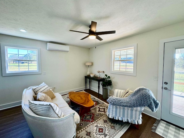 sitting room with plenty of natural light, dark wood-type flooring, and ceiling fan