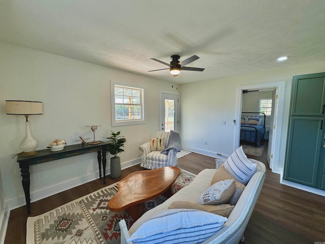 sitting room with ceiling fan, dark hardwood / wood-style floors, and a textured ceiling