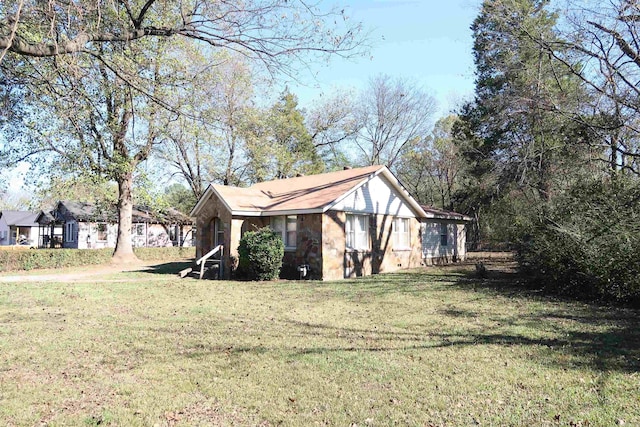 view of side of property with a lawn