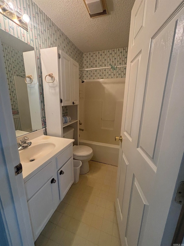 full bathroom featuring toilet, shower / tub combination, vanity, and a textured ceiling