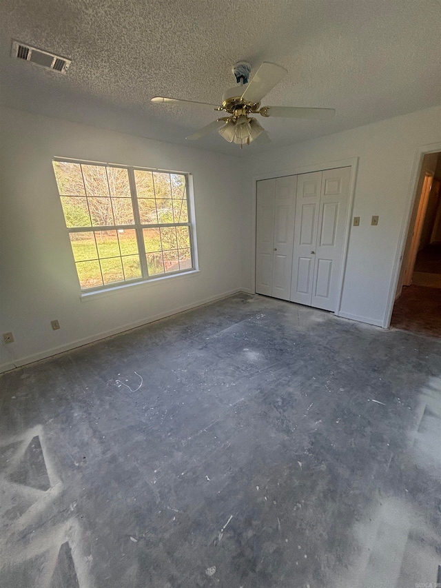 unfurnished bedroom with a closet, a textured ceiling, and ceiling fan