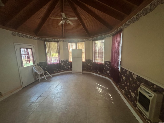 interior space featuring vaulted ceiling with beams, ceiling fan, wooden ceiling, and heating unit