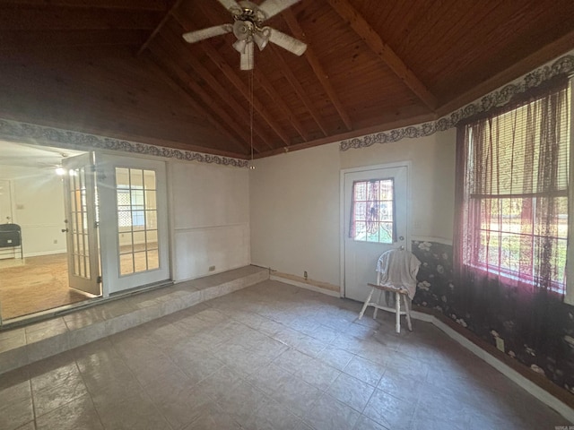 spare room with ceiling fan, wood ceiling, and vaulted ceiling with beams