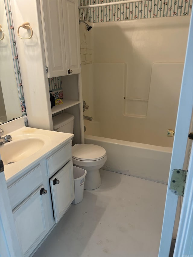 bathroom with toilet, vanity, and shower / bathtub combination