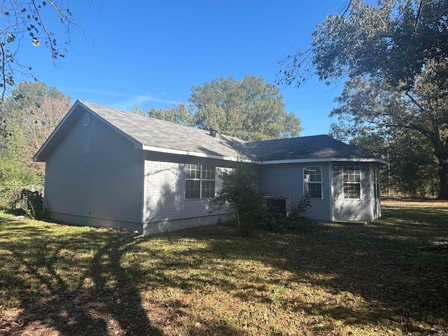 rear view of house with a yard