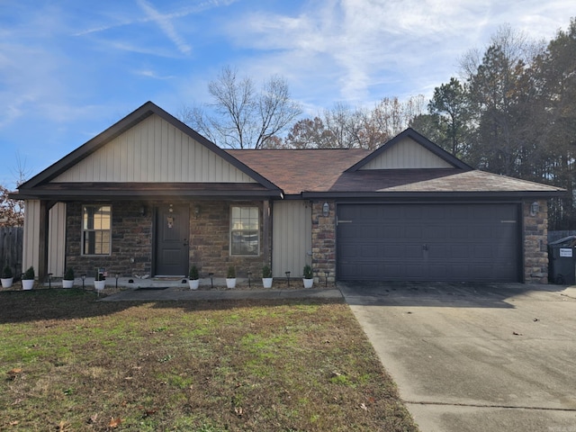 513 Saint Charles Ct, Haskell, AR 72015 - view of front of home with a garage, concrete driveway, stone siding, and a front lawn