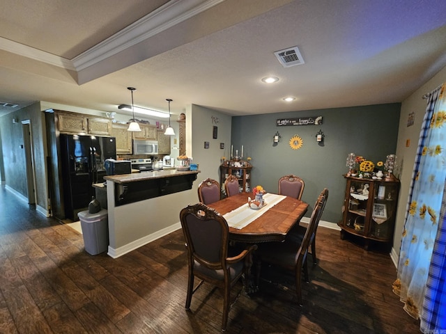 dining room with ornamental molding and dark hardwood / wood-style flooring