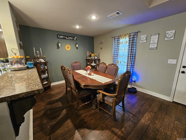 dining area with dark hardwood / wood-style floors