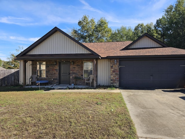 ranch-style home featuring a garage, a front lawn, and covered porch