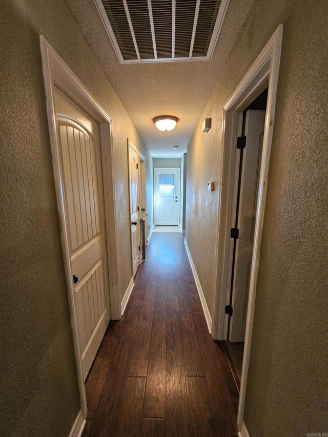 513 Saint Charles Ct, Haskell, AR 72015 - hall with dark wood finished floors, a textured wall, baseboards, and a textured ceiling