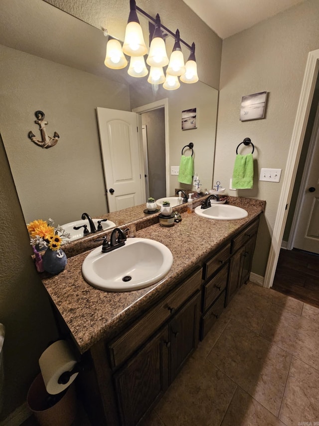 513 Saint Charles Ct, Haskell, AR 72015 - bathroom with double vanity, a chandelier, and baseboards