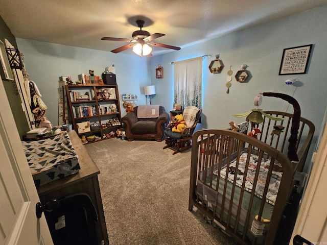 bedroom featuring ceiling fan, carpet flooring, and a nursery area