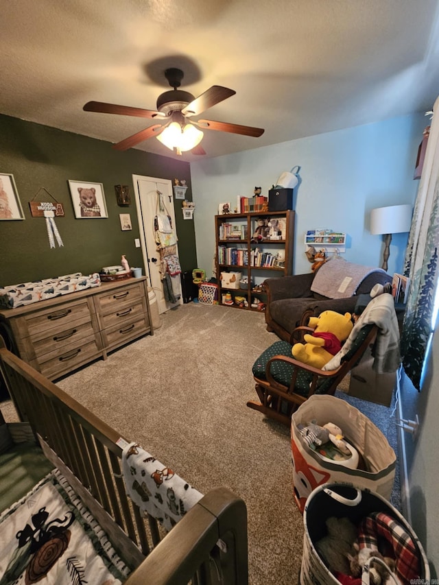 living room featuring ceiling fan, a textured ceiling, and carpet flooring