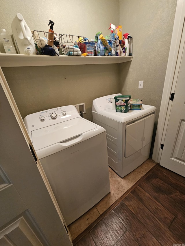 clothes washing area featuring washer and dryer and dark hardwood / wood-style floors