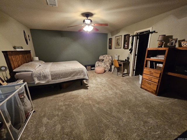 bedroom featuring ceiling fan, a textured ceiling, and carpet