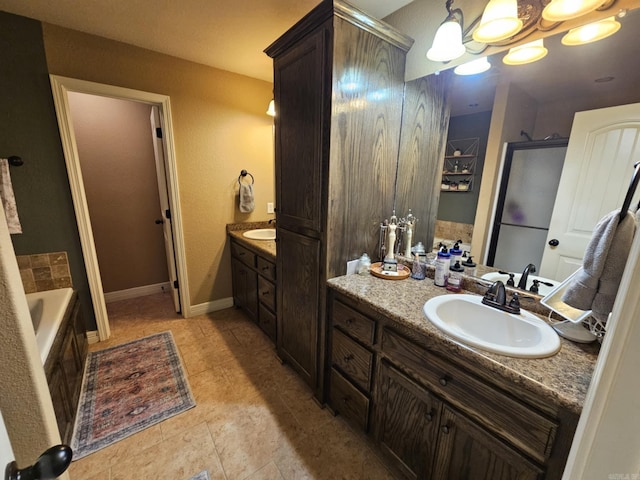 bathroom featuring a chandelier, vanity, and a washtub