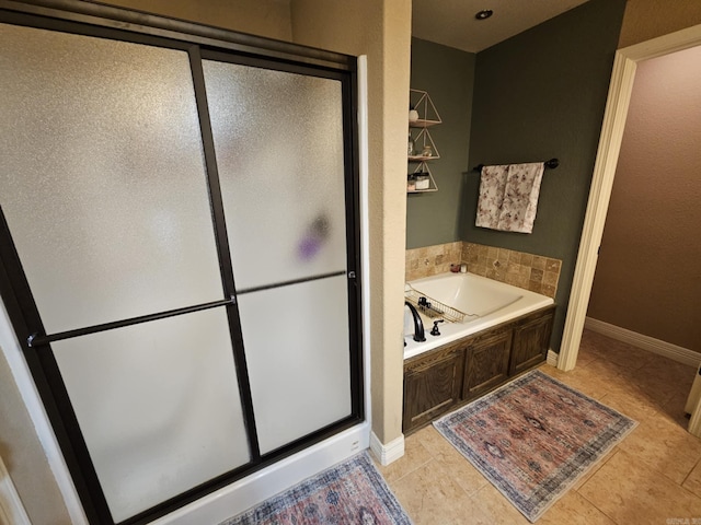 bathroom featuring plus walk in shower and tile patterned flooring