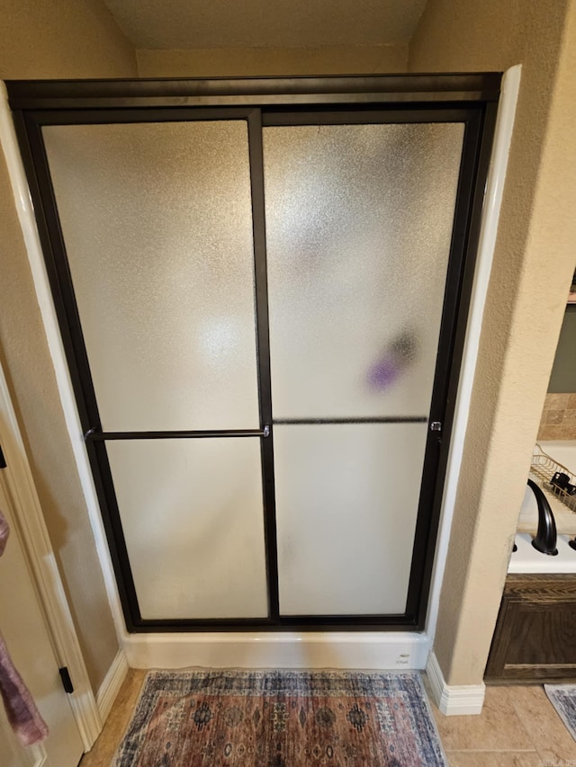 513 Saint Charles Ct, Haskell, AR 72015 - full bathroom with a stall shower, baseboards, and a bath