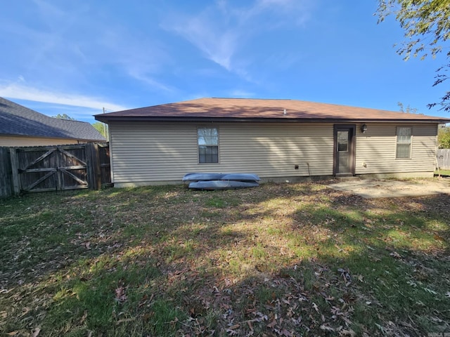 rear view of property with a lawn