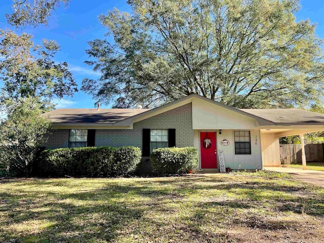 single story home featuring a front lawn and a carport