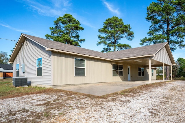 back of property with a patio area and central AC