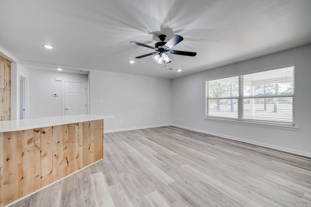 interior space with ceiling fan and light wood-type flooring