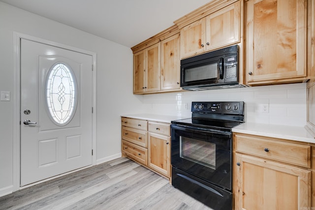 kitchen featuring light brown cabinets, tasteful backsplash, black appliances, and light hardwood / wood-style flooring