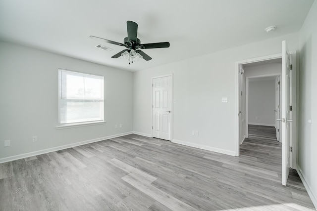 empty room featuring ceiling fan and light hardwood / wood-style flooring