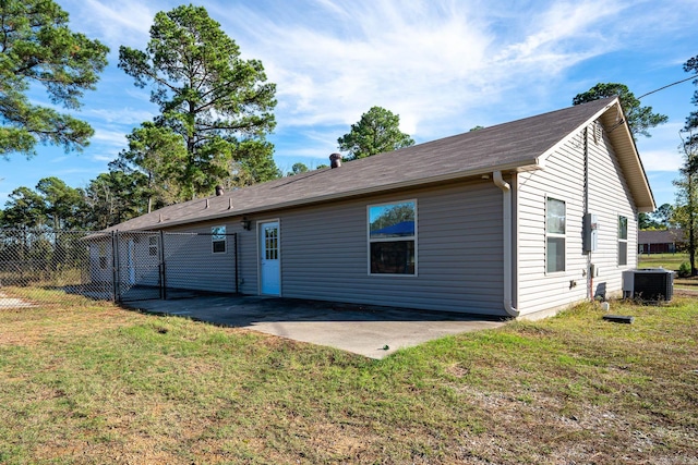 back of property featuring central air condition unit, a yard, and a patio area