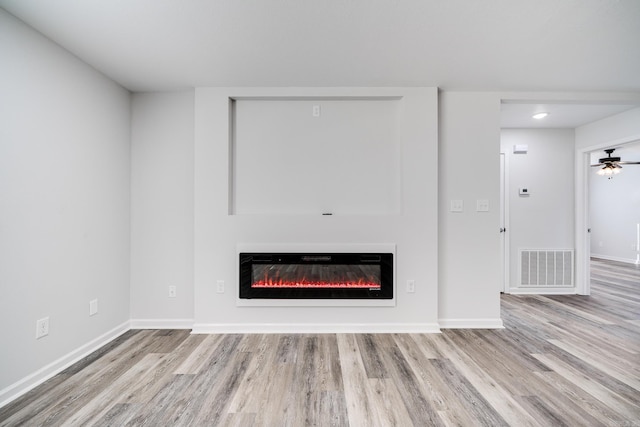 interior details with wood-type flooring and ceiling fan