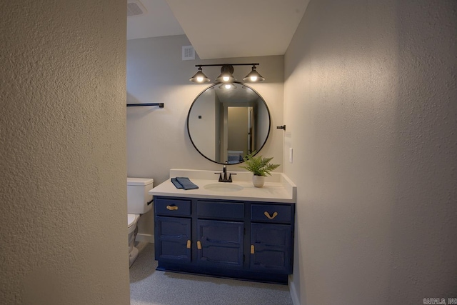 bathroom featuring toilet and vanity