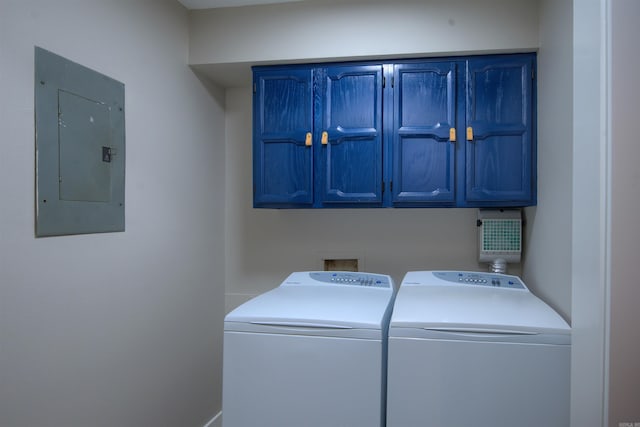 laundry area with washer and clothes dryer, electric panel, and cabinets