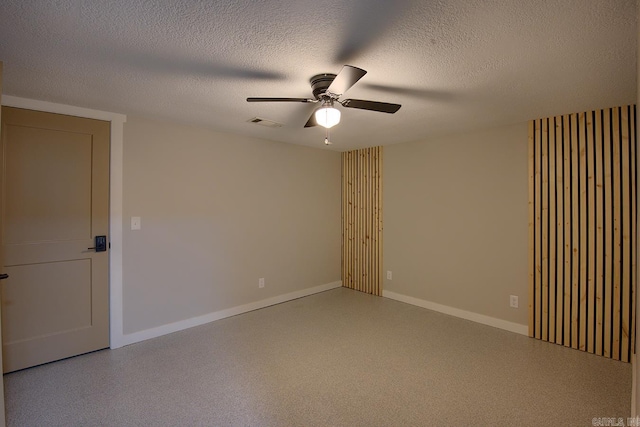 empty room with a textured ceiling and ceiling fan