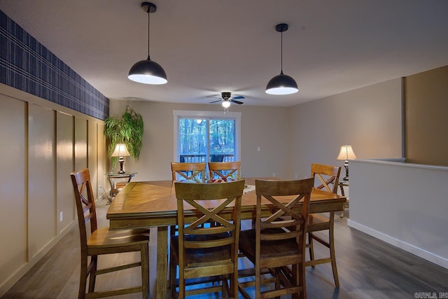 dining space with dark wood-type flooring and ceiling fan