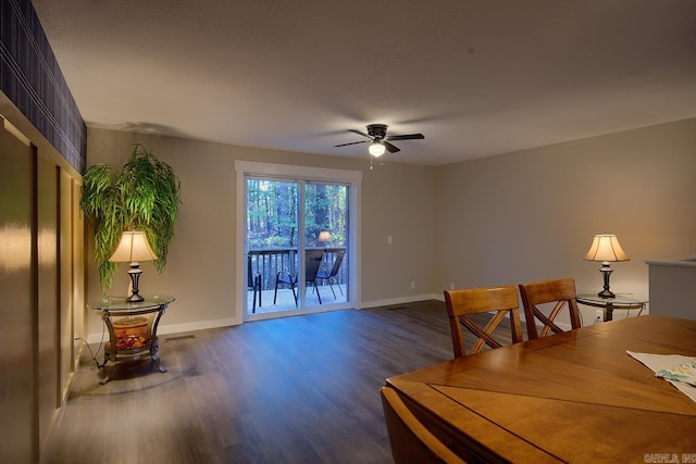 dining room with dark hardwood / wood-style flooring and ceiling fan