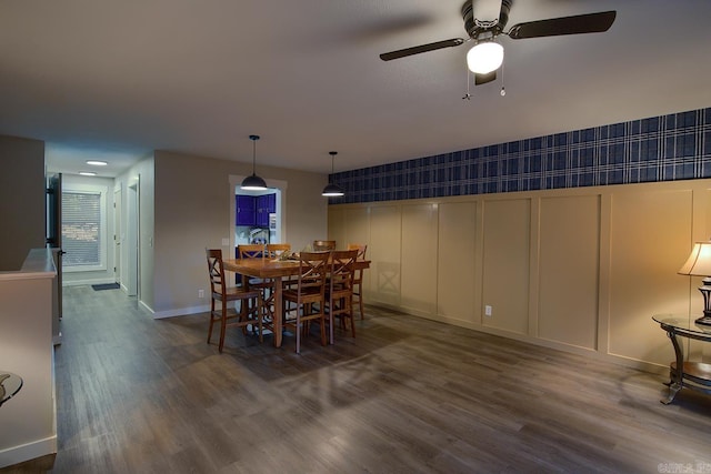 dining space with dark wood-type flooring and ceiling fan