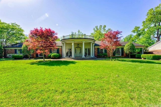 exterior space with a balcony, a lawn, and covered porch