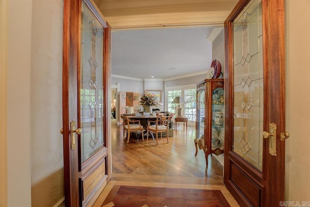 interior space featuring hardwood / wood-style floors, french doors, and ornamental molding