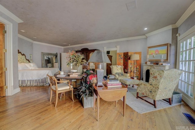 living room featuring light hardwood / wood-style floors and ornamental molding