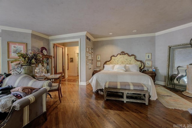 bedroom with crown molding and dark hardwood / wood-style flooring