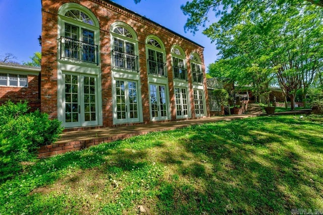 rear view of house featuring a yard