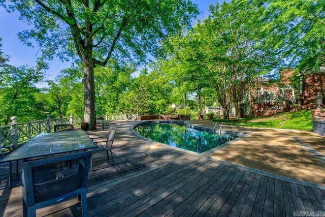 view of swimming pool with a wooden deck